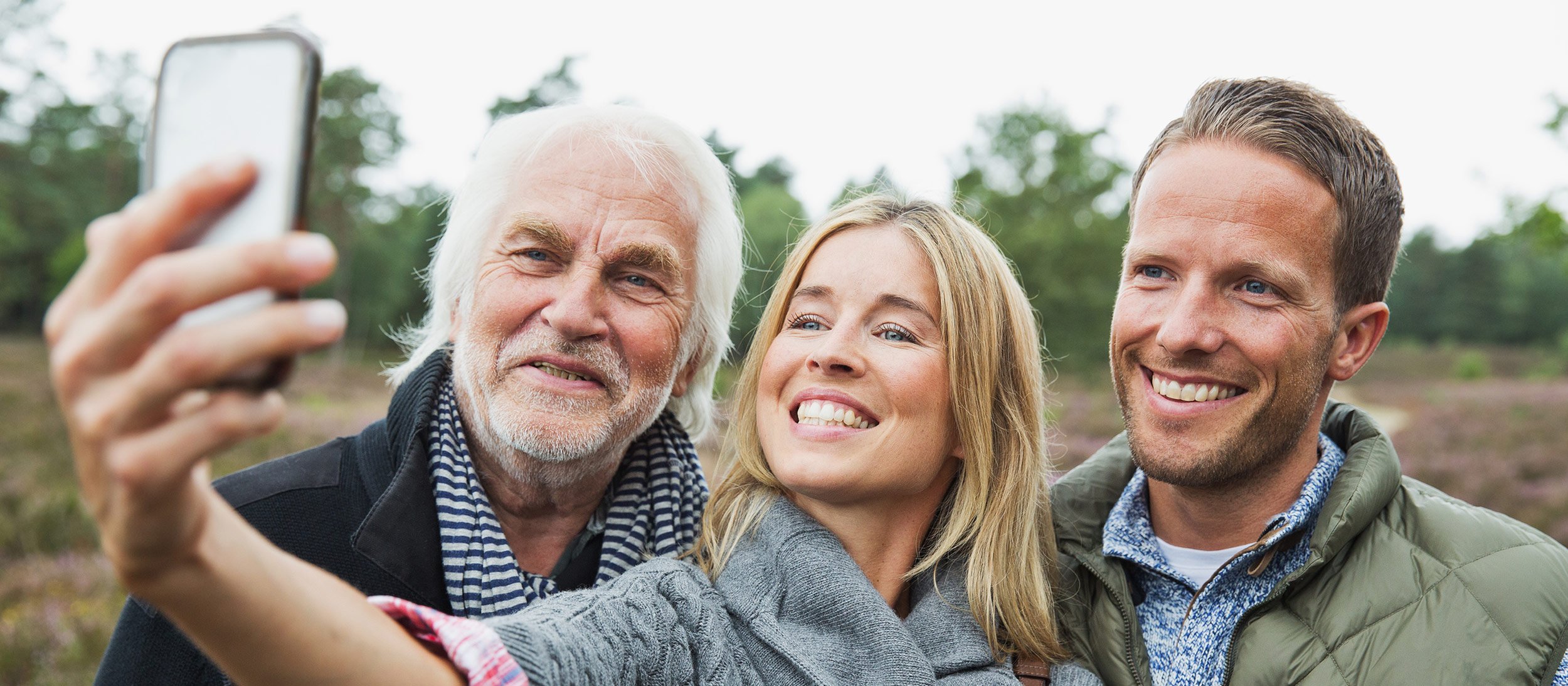 Grandfather posing for a selfie with his grandchildren