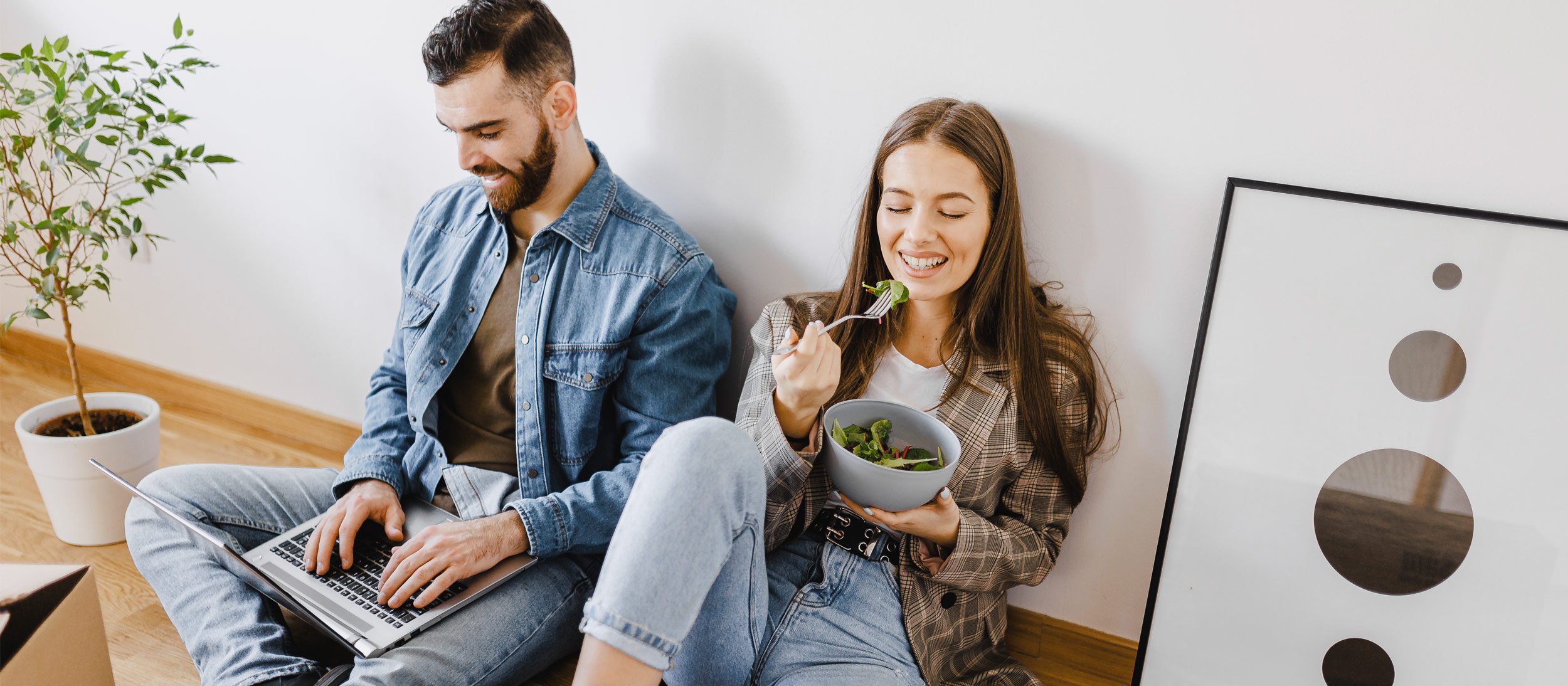 Couple sitting on the floor enjoying life