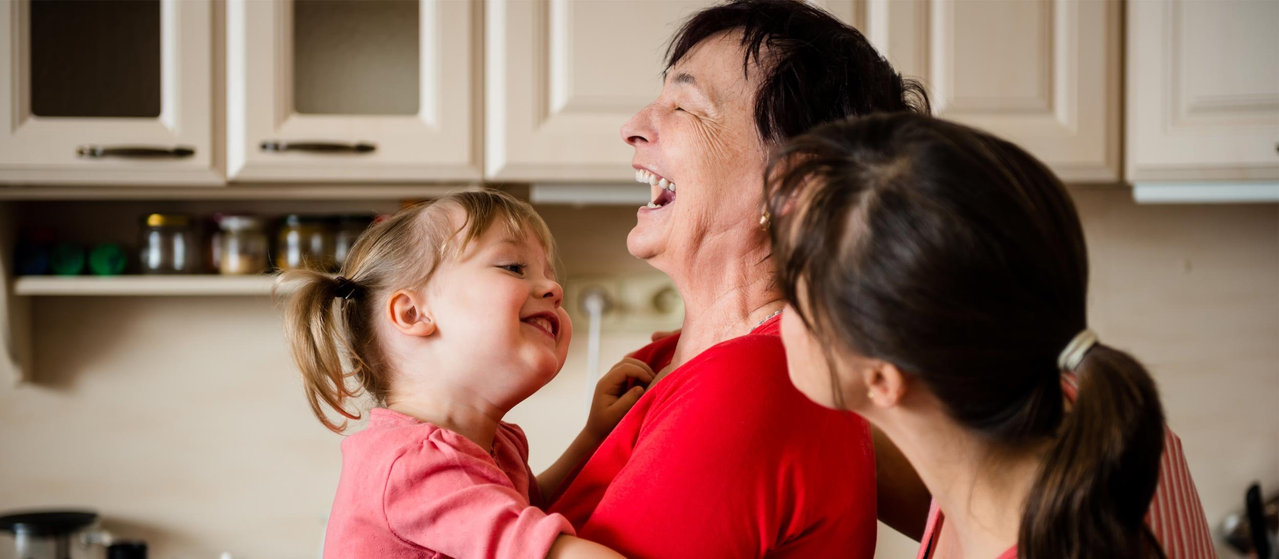 Family laughing in the kitchen