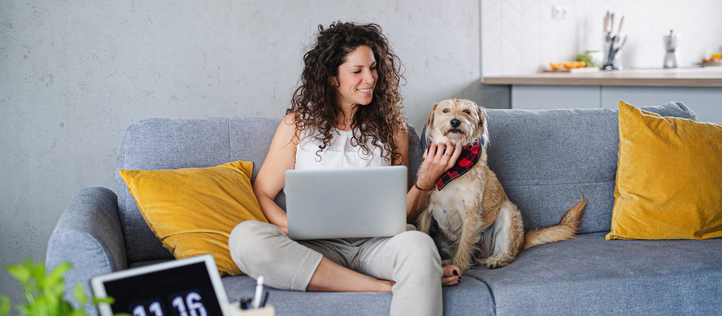Woman sitting on her couch with her dog