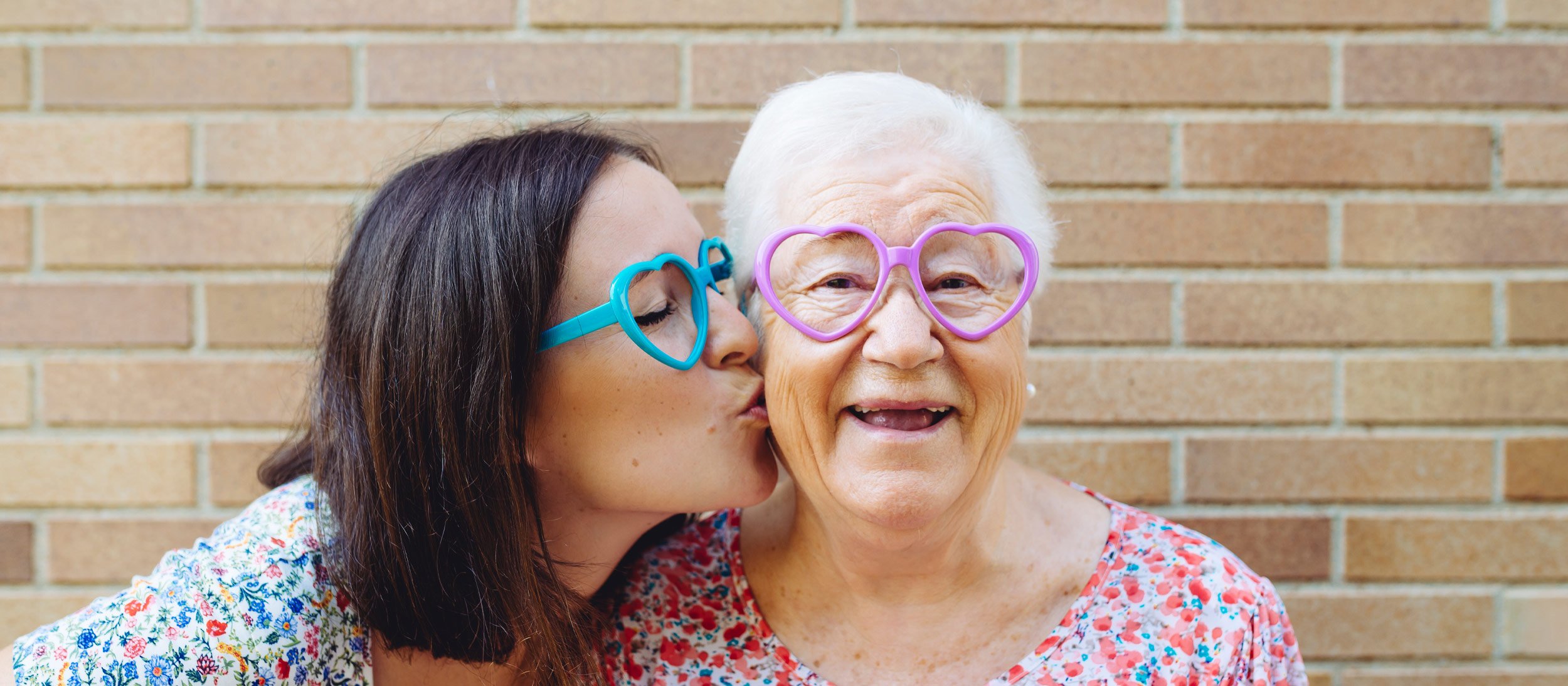 Daughter kissing her smiling mother