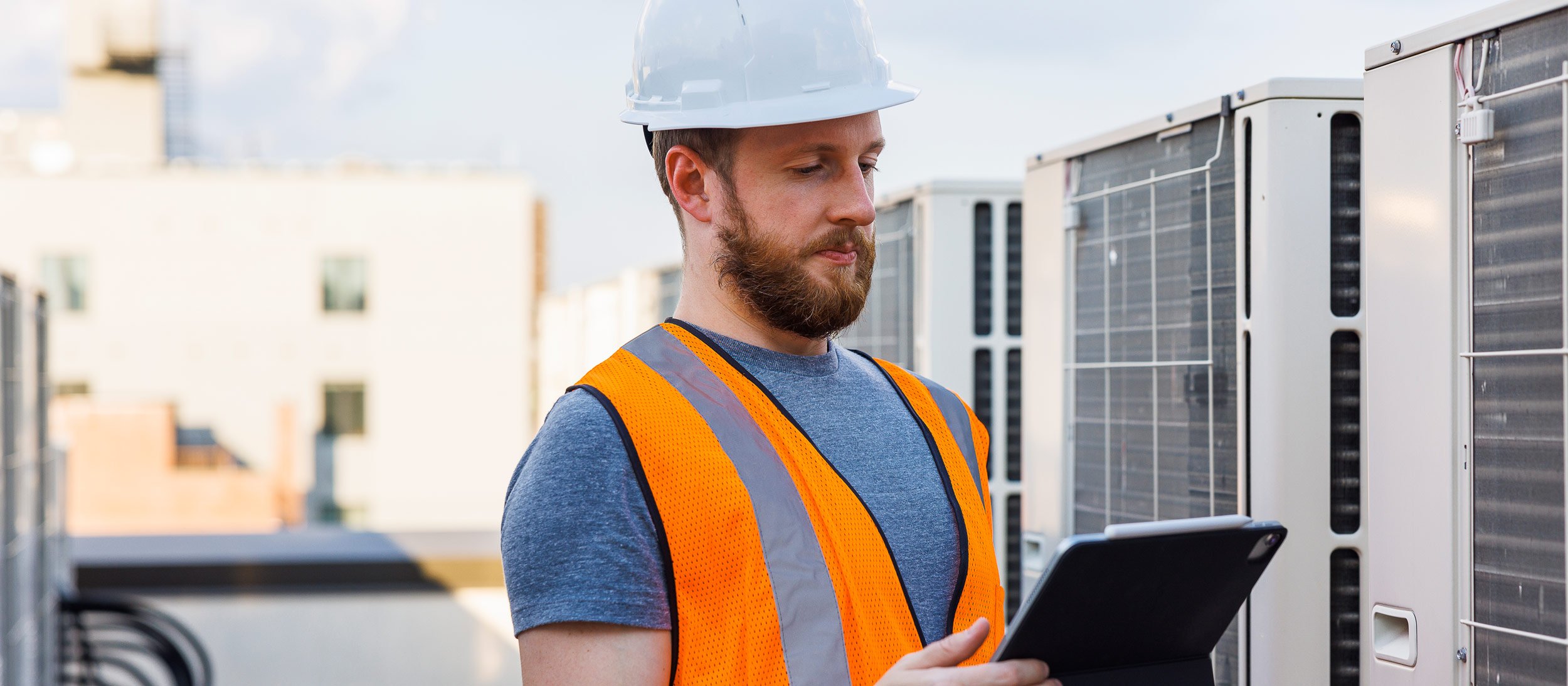 Maintenance worker reviewing an air conditioner