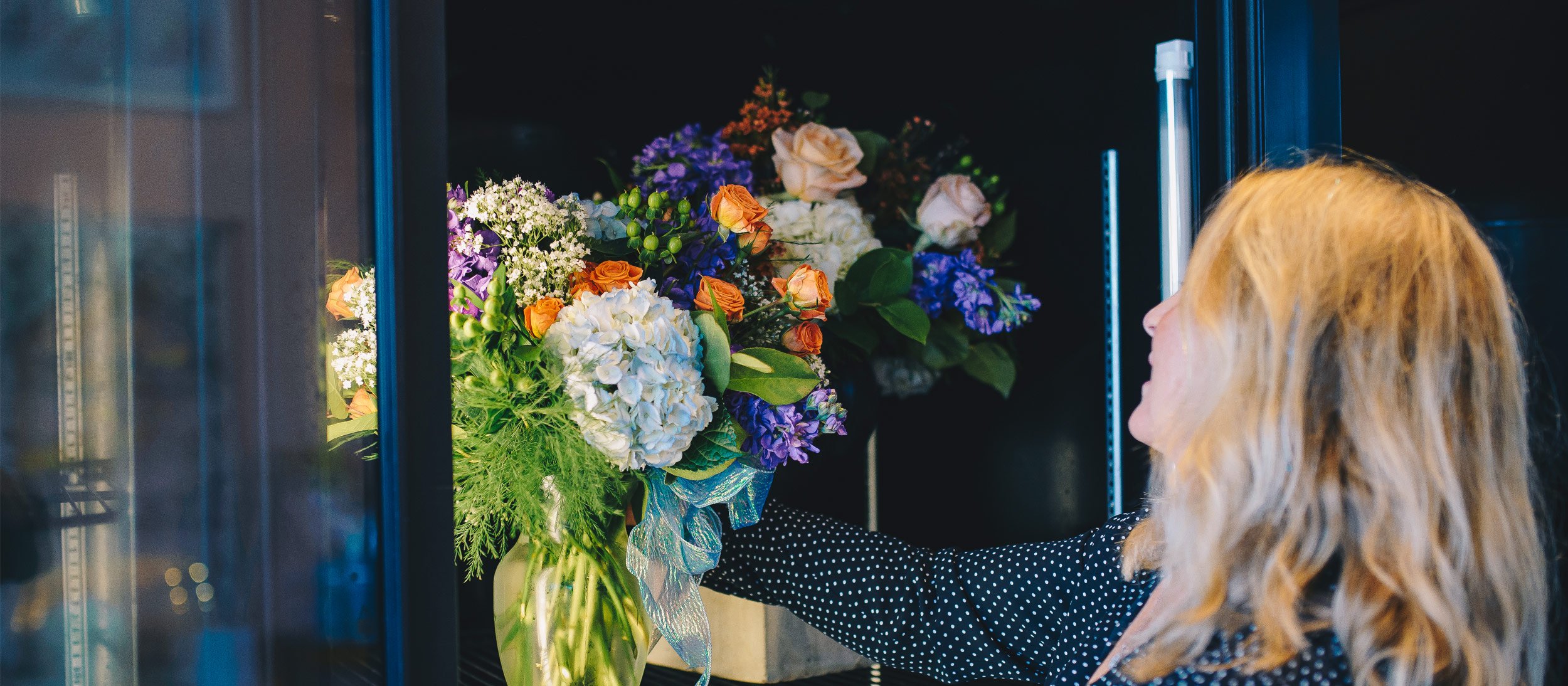 A florist displaying a bouquet