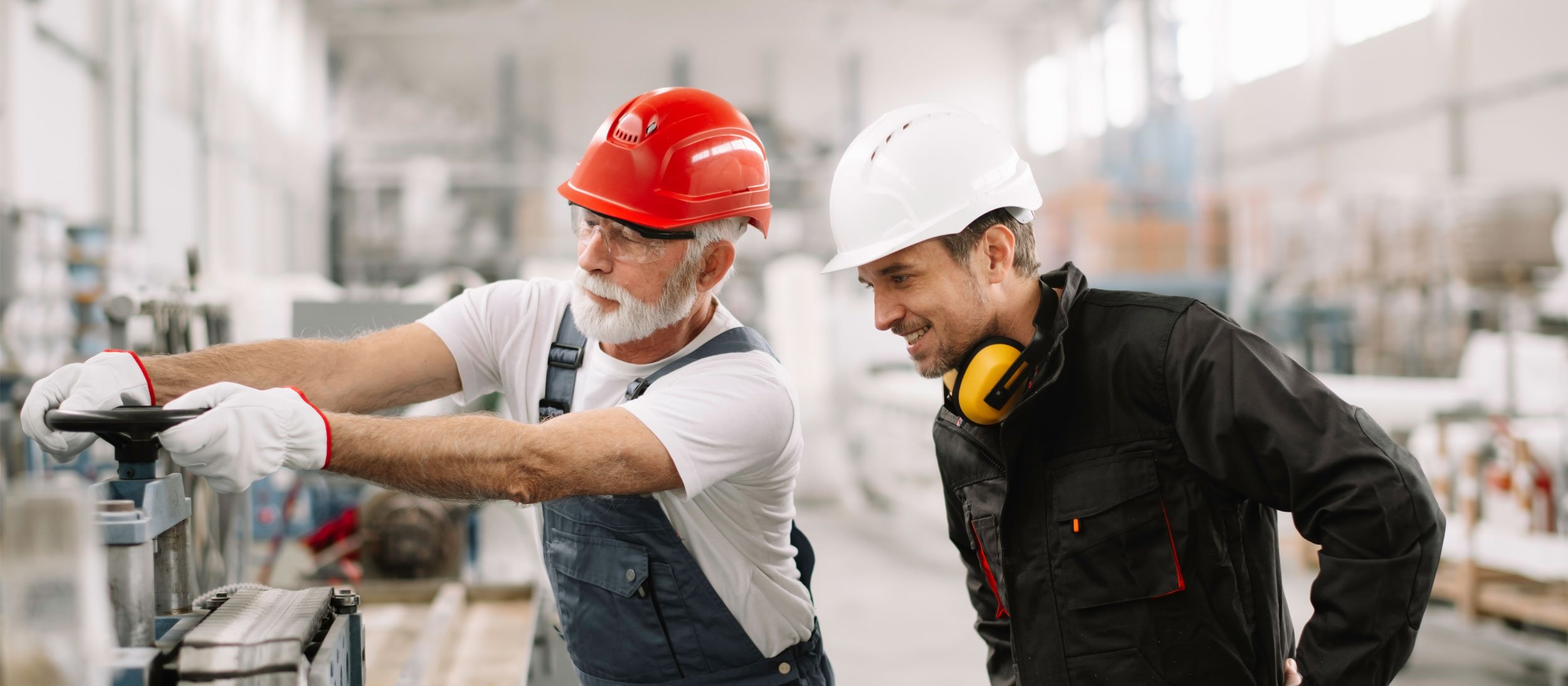 Supervisor monitoring an employee while they turn a valve