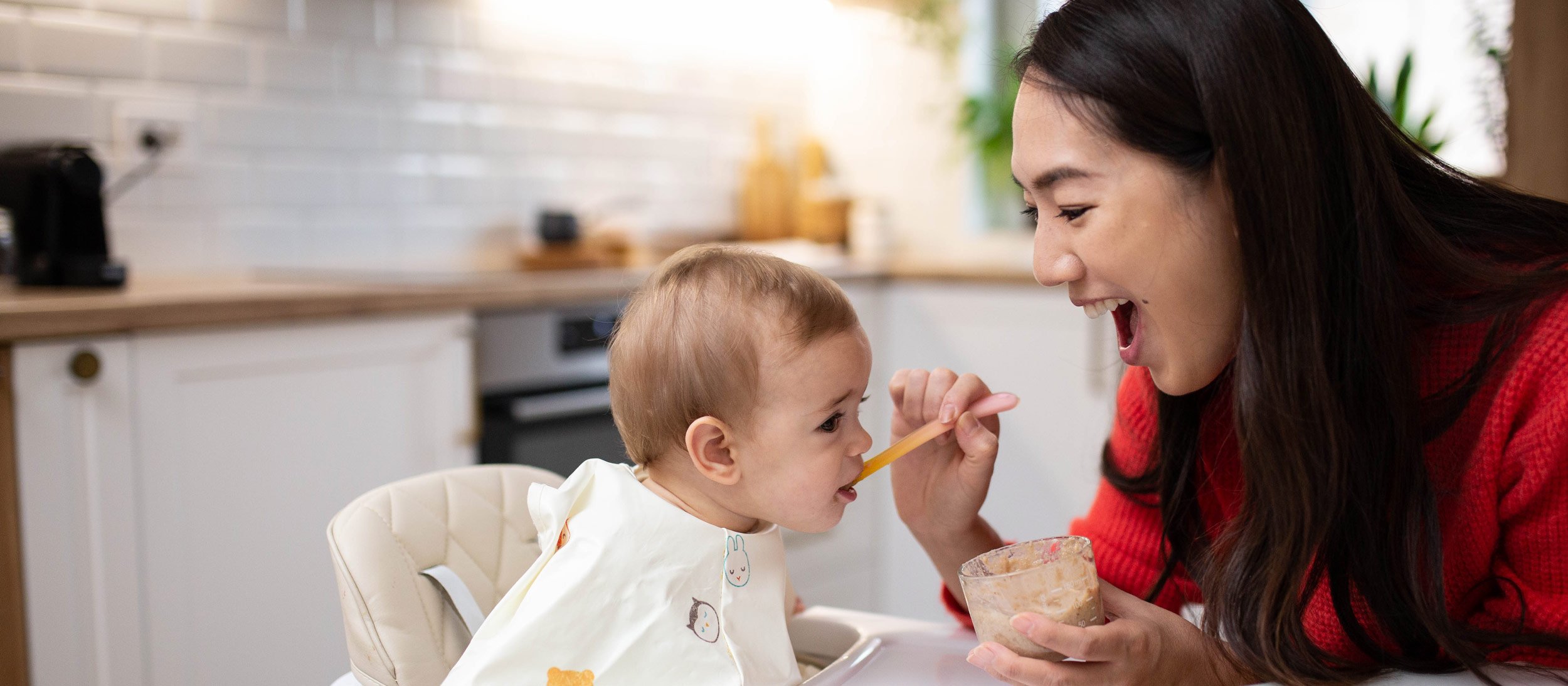 Nanny feeding a baby