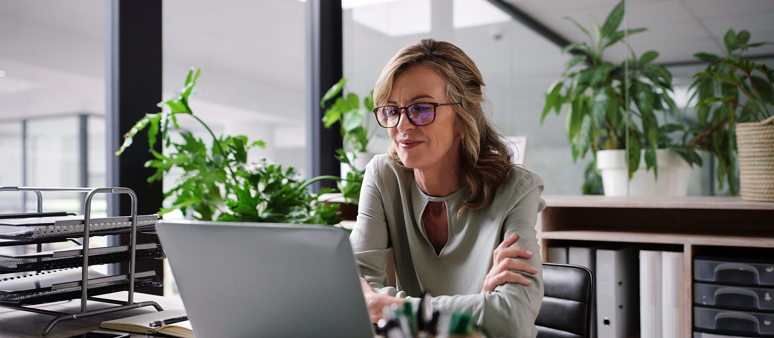 Woman reviewing documents on her laptop