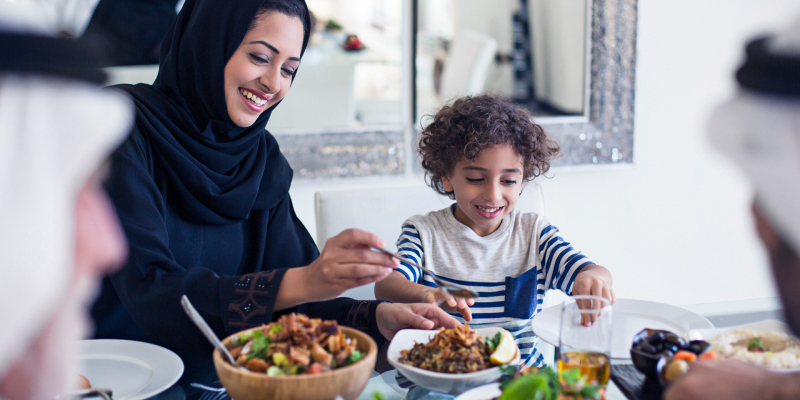 boy eating dinner with mom