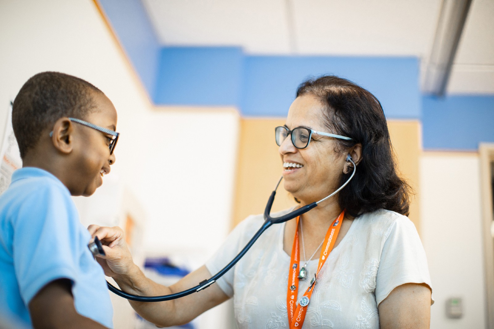 Provider with stethoscope with young patient