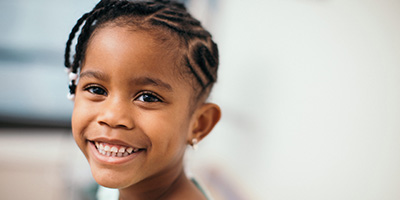 Young Girl Smiling in Exam Room