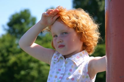 girl with hand on head