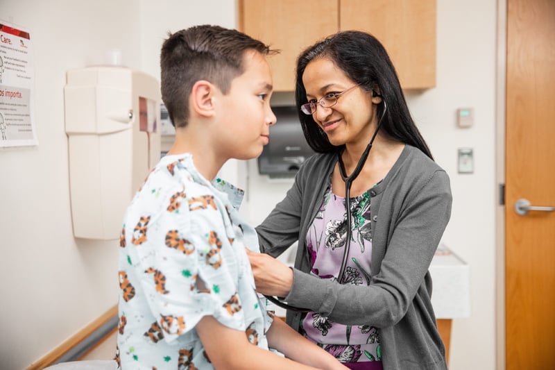 Cardiology Provider using Stethoscope on Patient