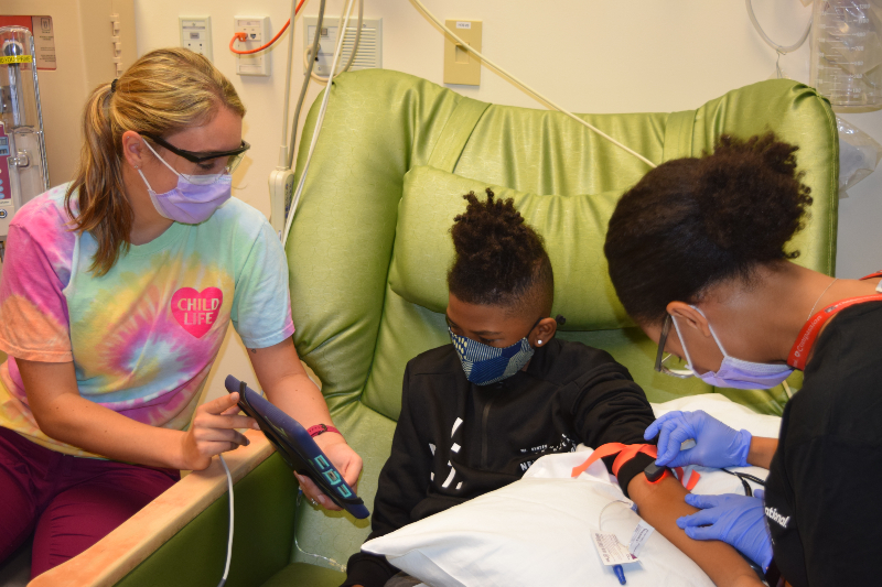 child life specialist assists child patient