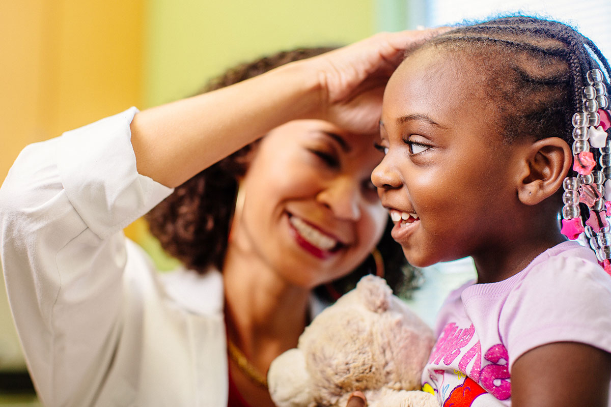 Doctor examining child's ear