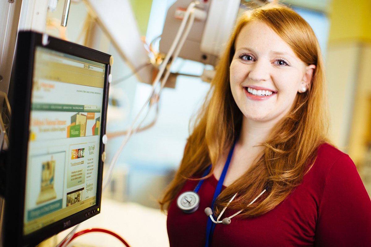 nurse with red hair at computer