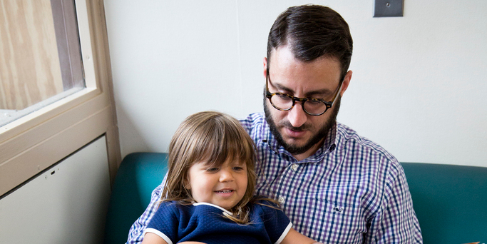 dad sitting with child in lap