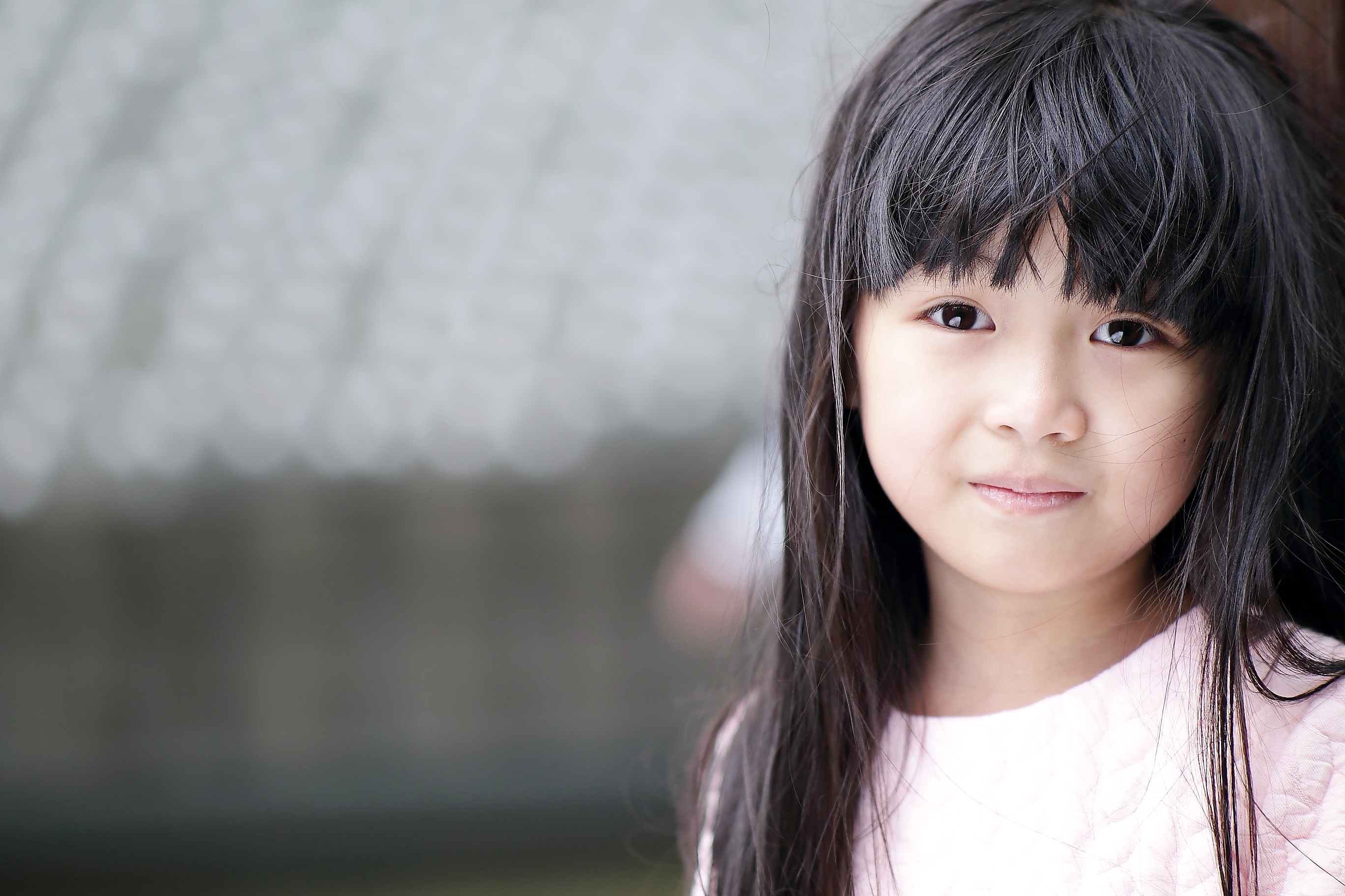 Young girl smiling slightly at camera