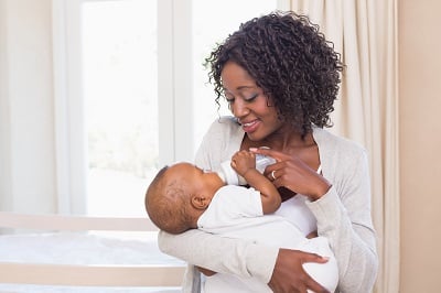 Mom holding baby with bottle