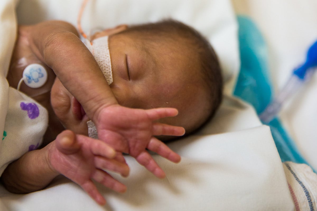 Preemie baby stretching in the children's hospital NICU