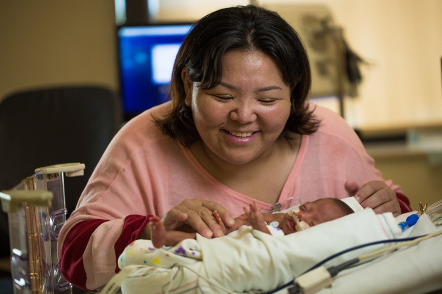 Mother caring for premature baby