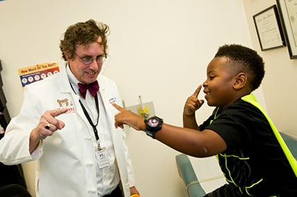 Doctor doing nose-touching test with young male patient