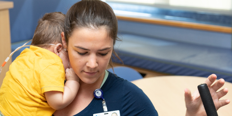 Nurse holding infant