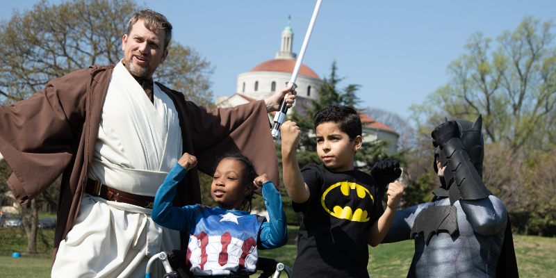 Man dressed as Obi Wan Kenobi with kids in costume