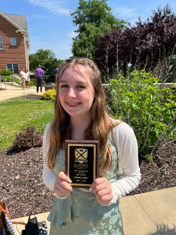 Alicia holding award