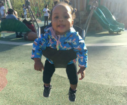 Amarie swings in a park swing