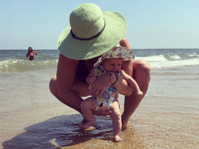 Sadie and Sadie's mother walking on a sandy beach