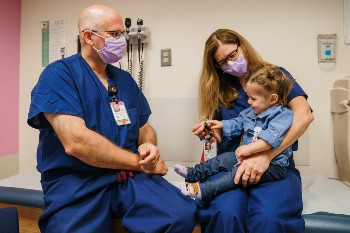 girl being held by provider