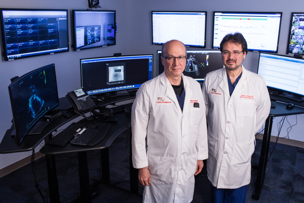 two doctors standing in front of computer screens