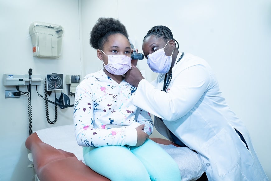 Doctor examines patient's ear in the mobile health van.