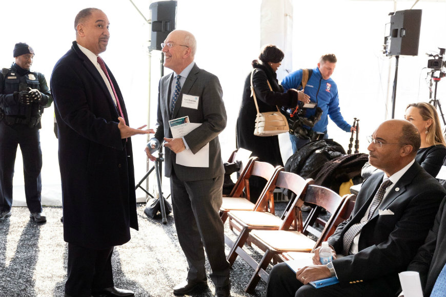 Dr. Newman speaks with attendee behind the scenes at the ceremonial groundbreaking event.