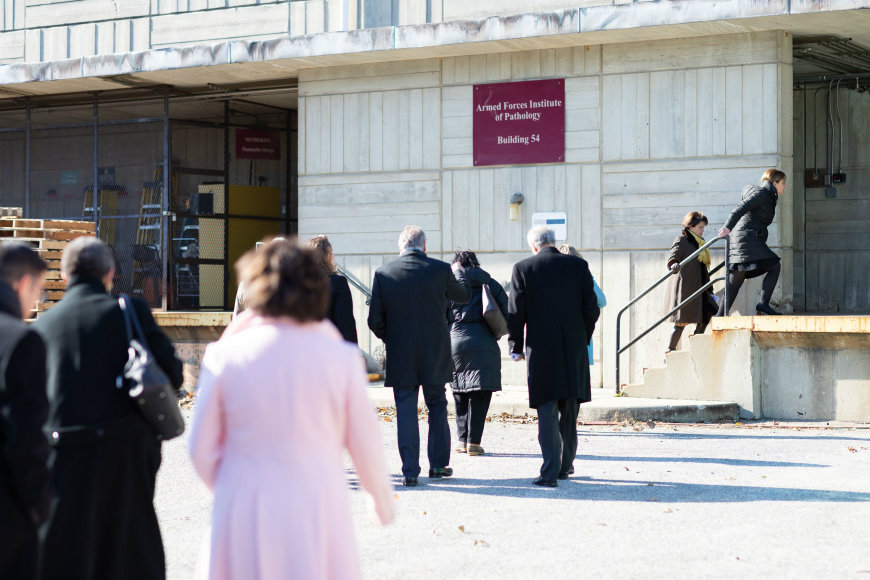 Attendees climb stairs and enter the future pediatric Innovation and Research Campus.