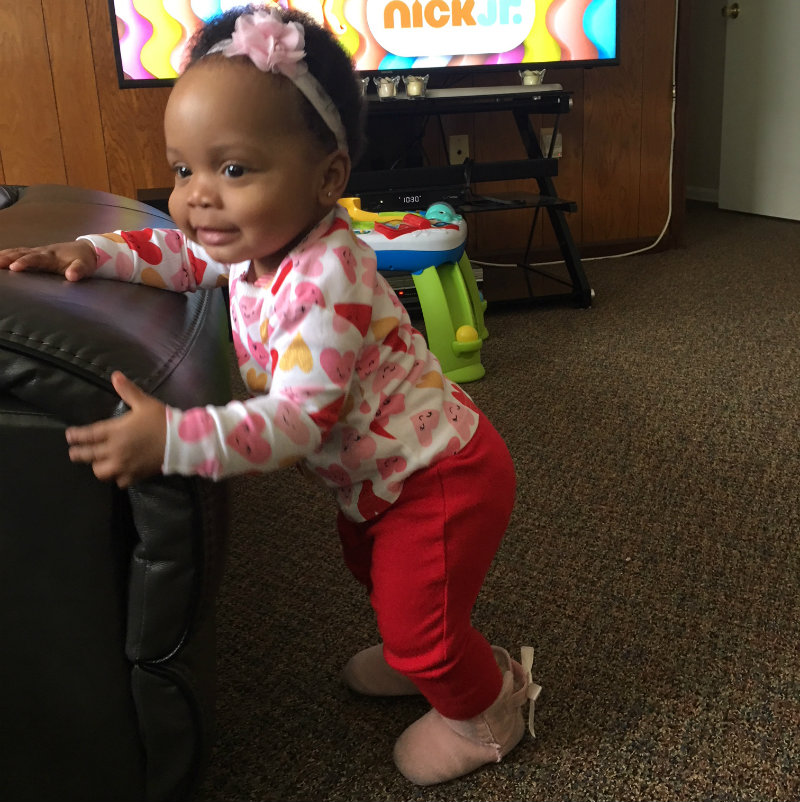 Amarie stands by the couch