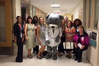 Patient and Family Advisory Council volunteers with Children's National mascot Dr. Bear