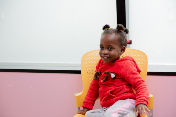 Young girl on orange chair