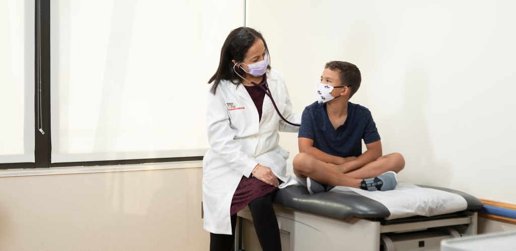 Provider with young boy in exam room