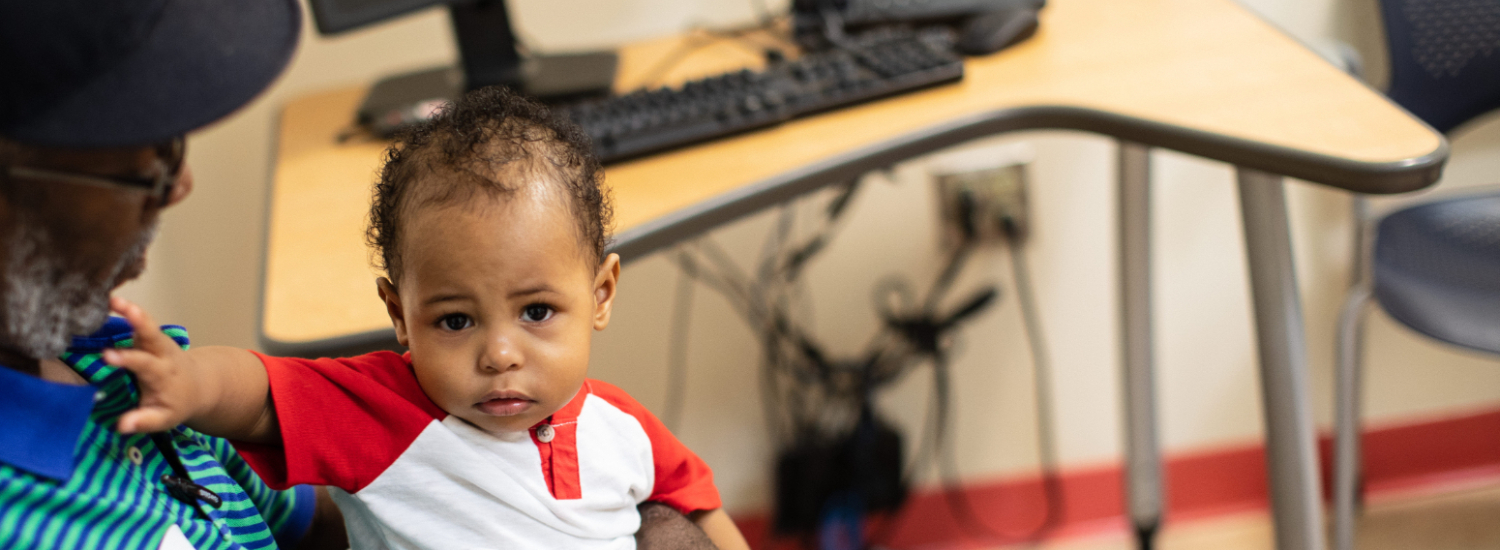 Infant sitting on lap