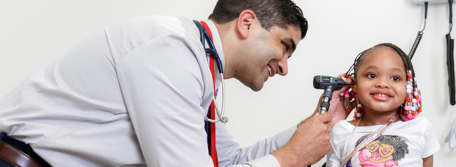 Provider checking girl's hearing