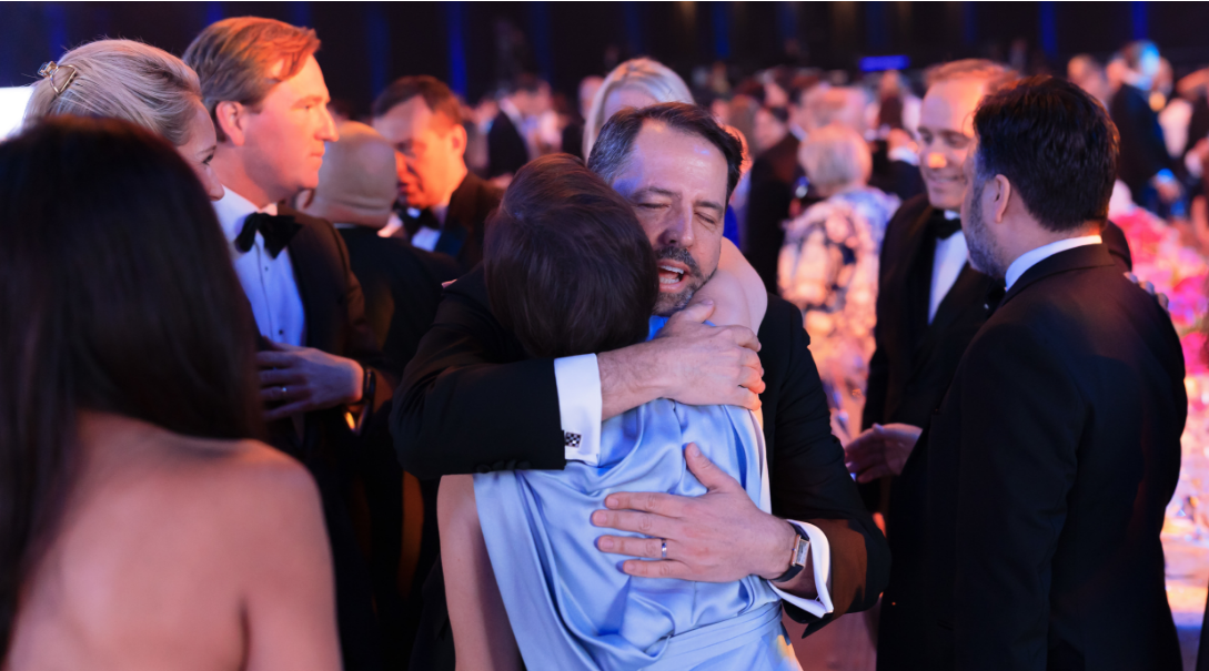 Children's Ball attendees embrace.