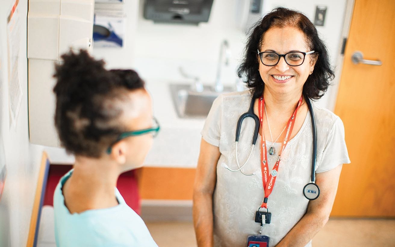 A White, female nephrology practitioner consults with a young female patient.