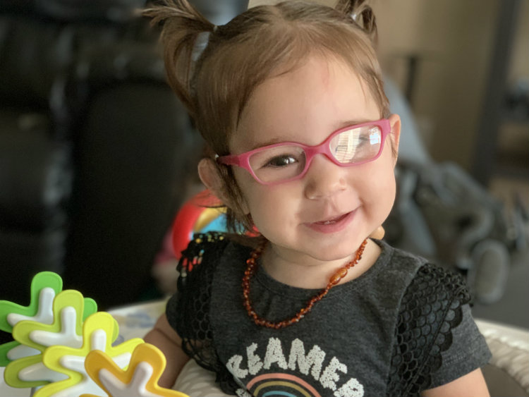 Baby Bella in pigtails and smiling