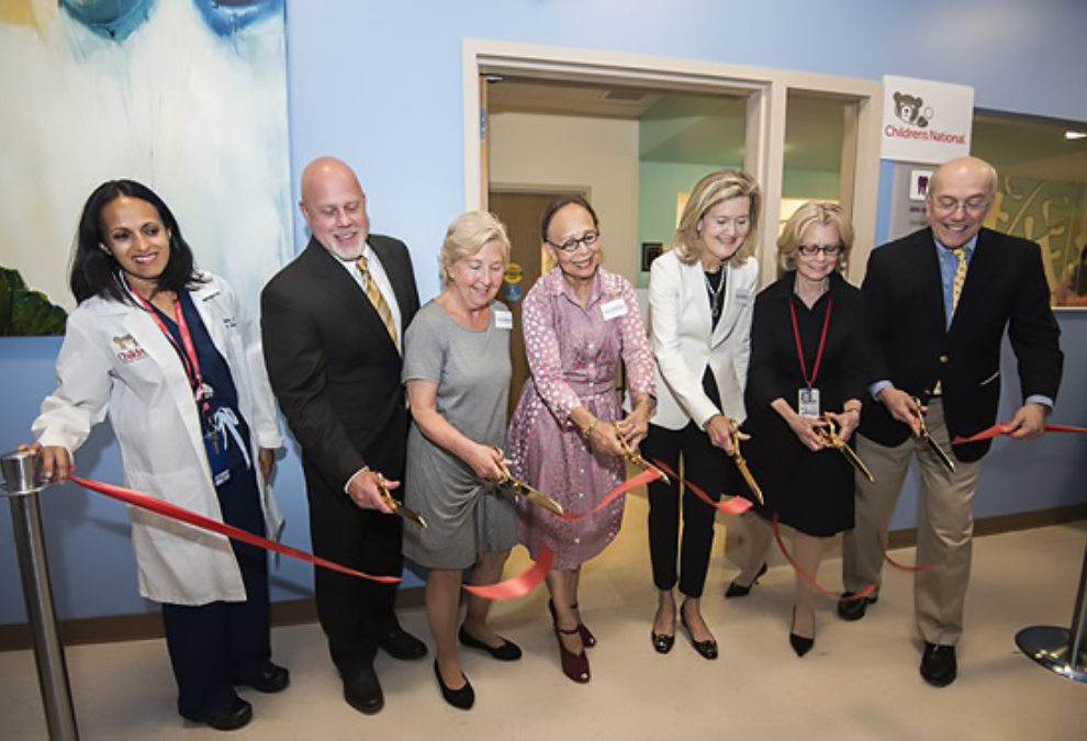 Members of the Founders Auxiliary Board at a ribbon cutting ceremony.