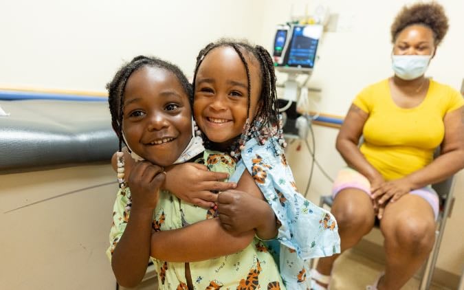 Photo of two Black elementary school aged female patients.