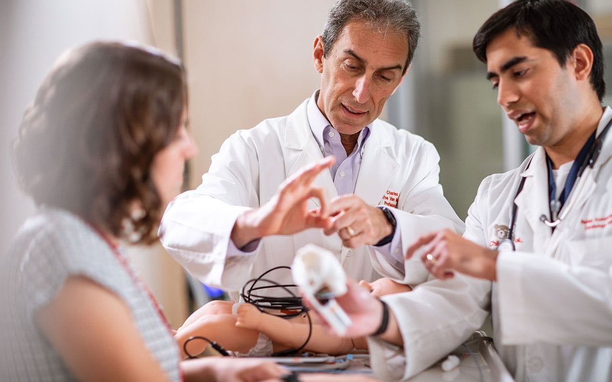 A doctor demonstrates an airway-related procedure.