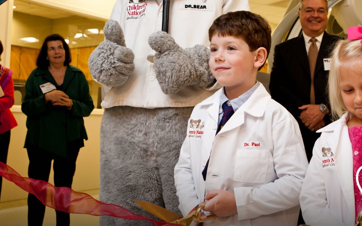 Young Paul Baier cuts the ribbon at a ceremony at Children's National Hospital.