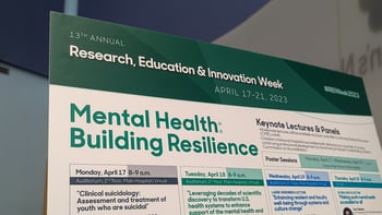 REI Week 2023 schedule poster board.