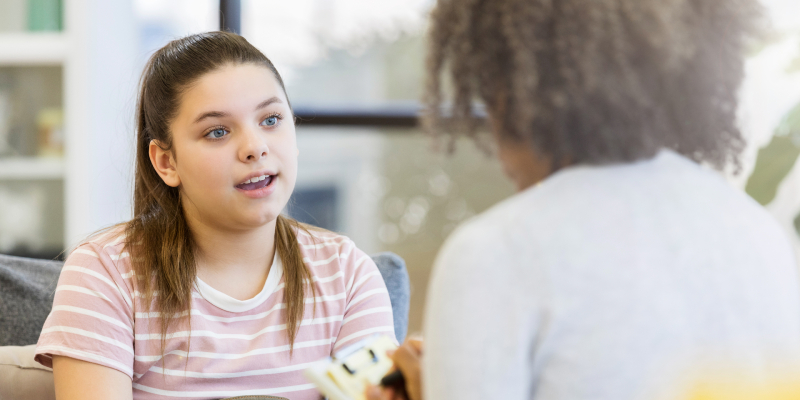 Teen girl talking to an adult.