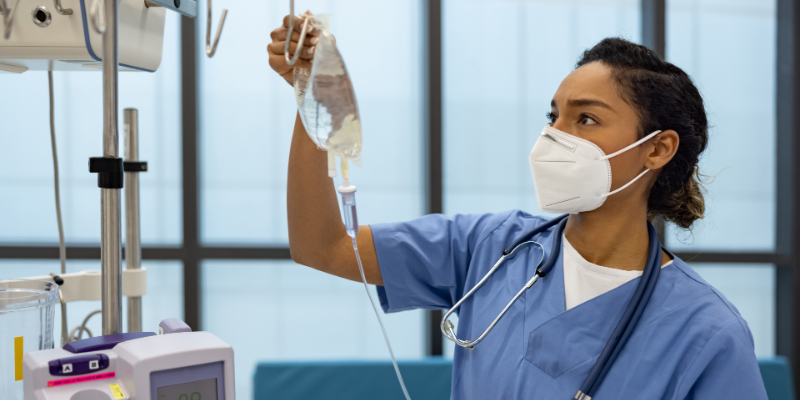 Nurse holding an IV bag.